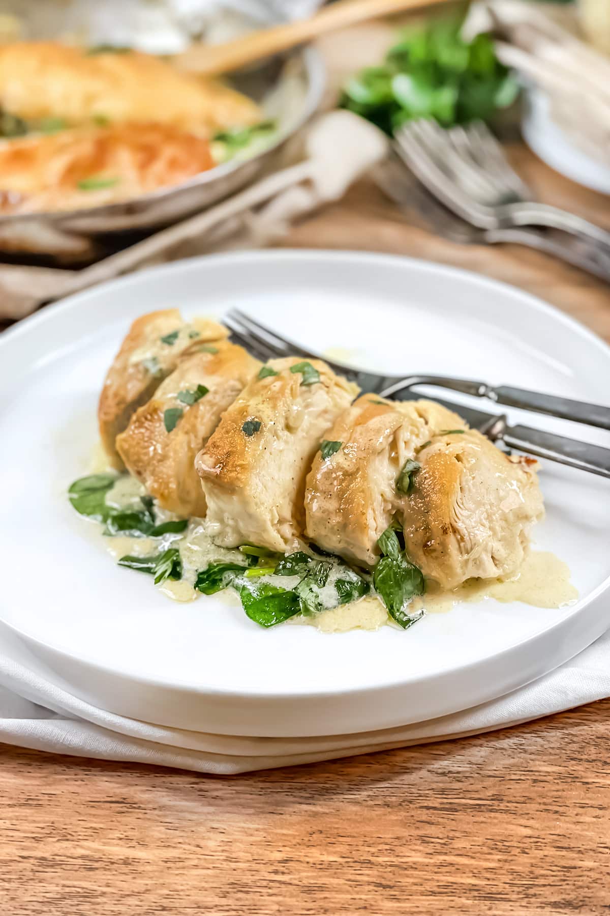 Sliced chicken florentine on a white plate.