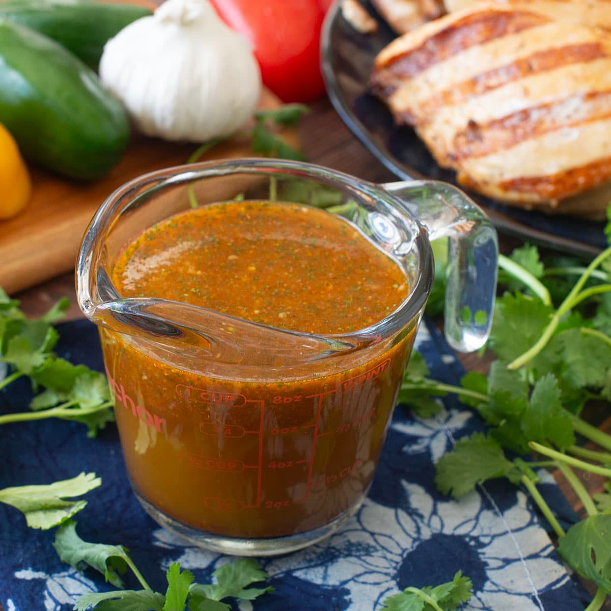 Glass measuring cup of Mexican chicken marinade.