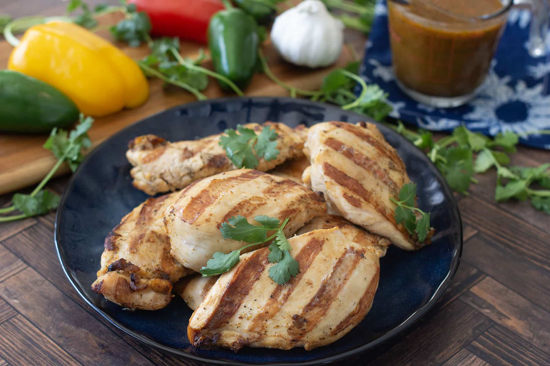 Marinated and grilled chicken breasts on plate.