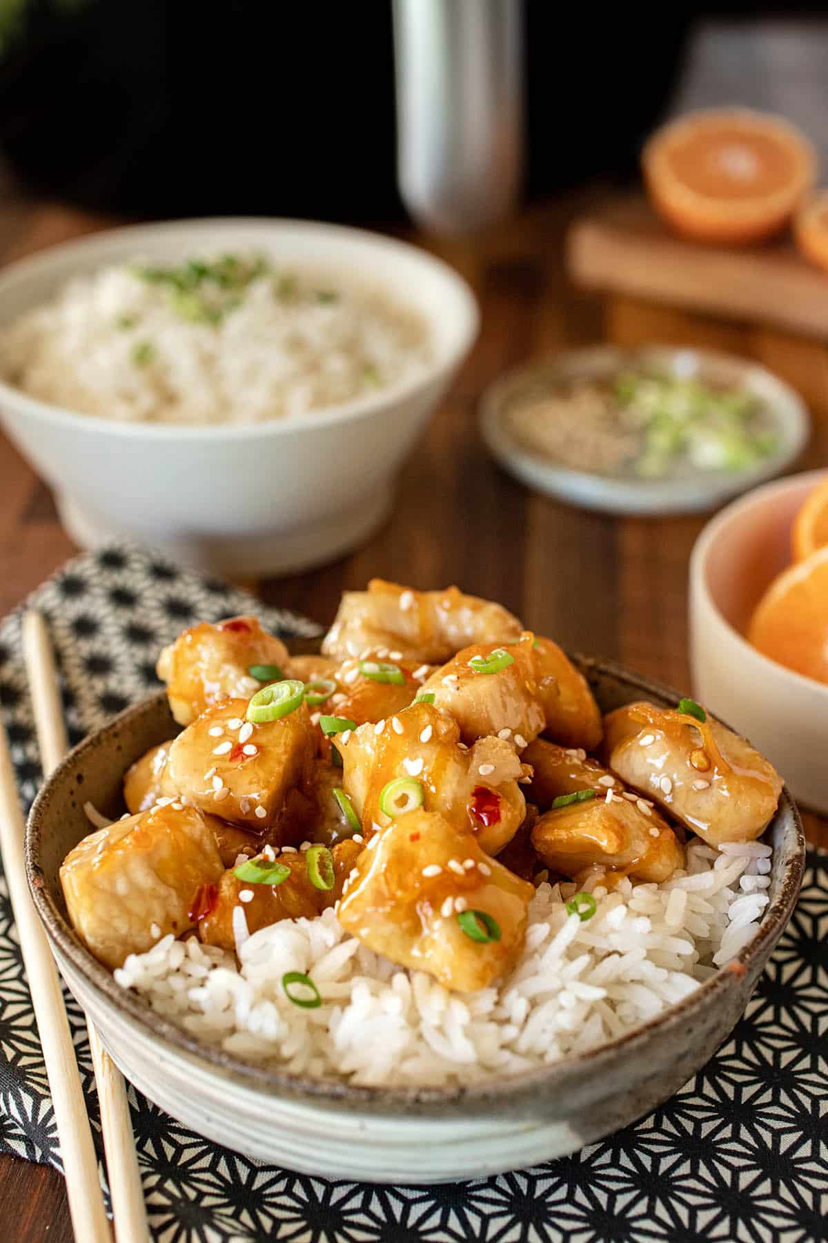 Bowl of white rice and orange chicken.