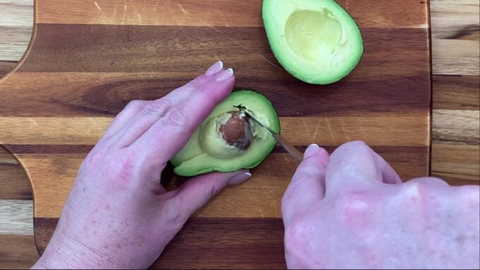 Cutting out an avocado pit.