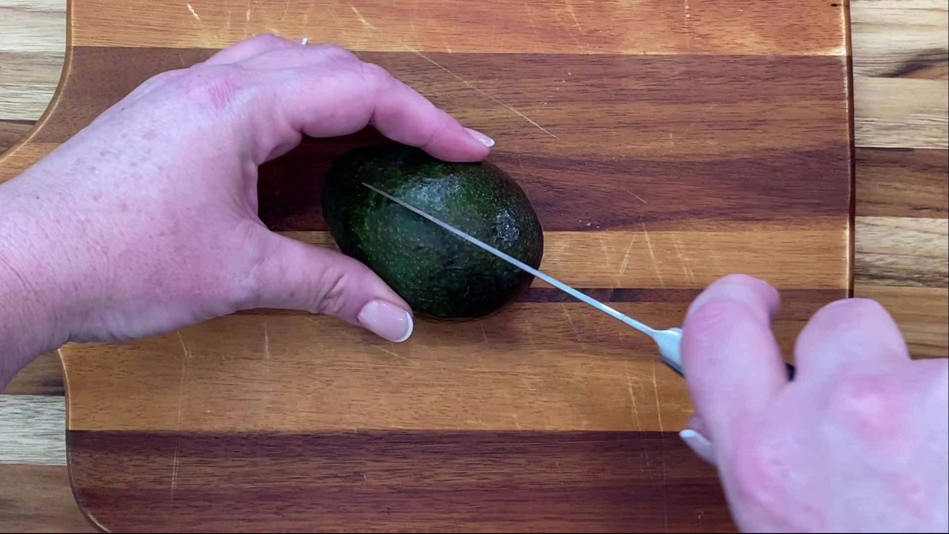 Cutting an avocado in half.