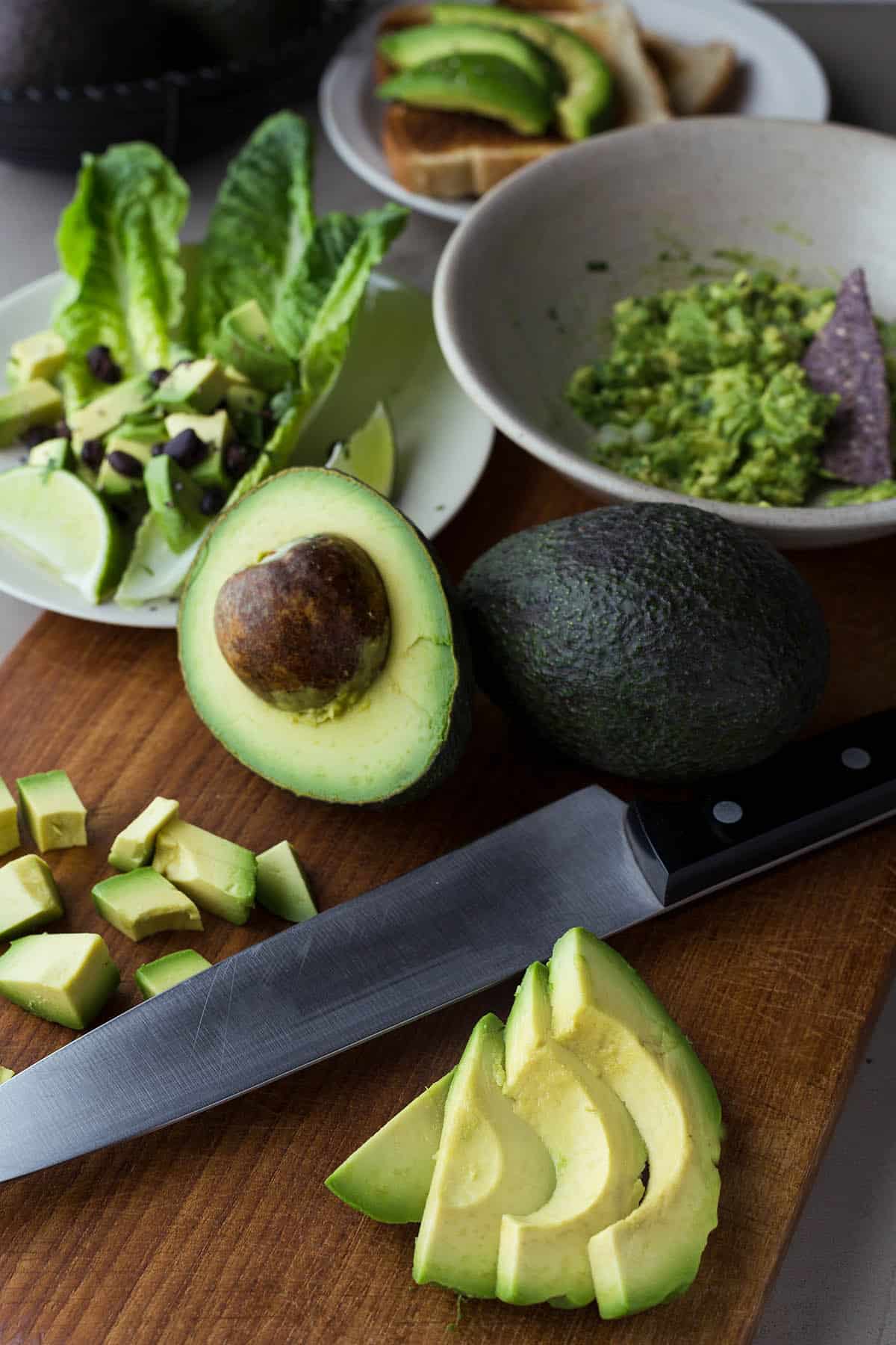 Avocado in slices, cubes, half, and mashed.