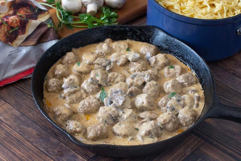 Pan of meatballs in creamy mushroom sauce.