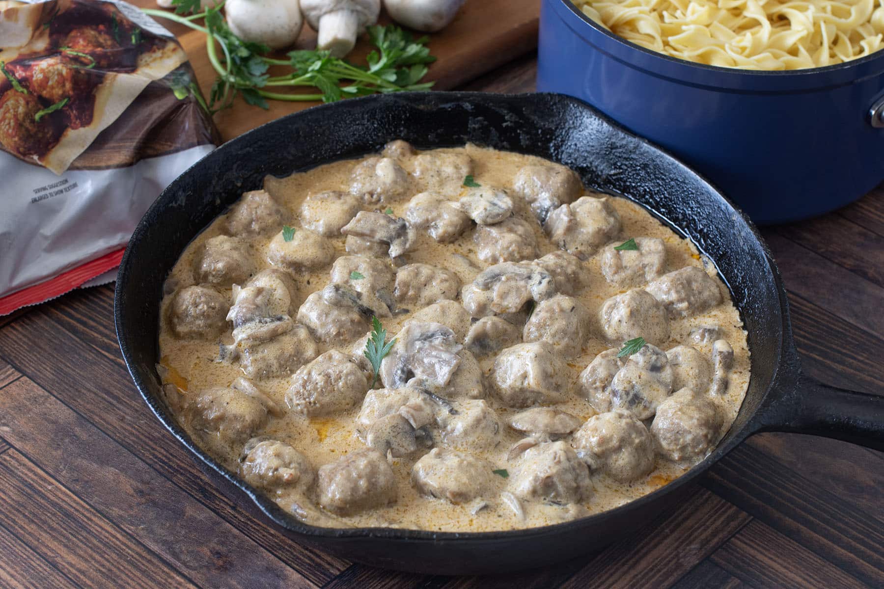 Pan of meatballs in creamy mushroom sauce.