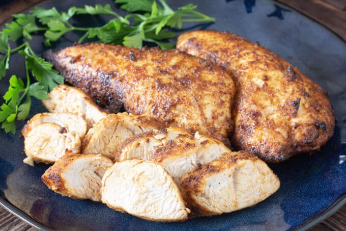 Turkey tenderloins on blue plate.