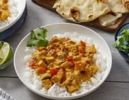 White dish with rice and chicken curry.