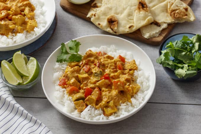 White dish with rice and chicken curry.